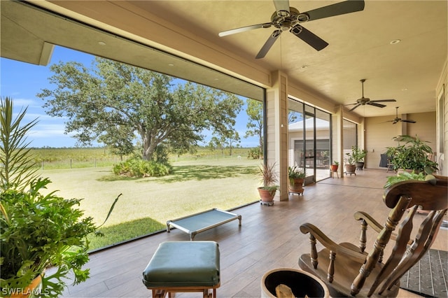 view of patio with ceiling fan and a rural view