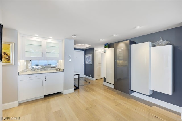 kitchen featuring white cabinetry and light hardwood / wood-style flooring