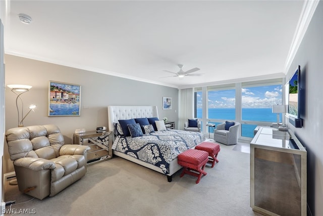 carpeted bedroom featuring ceiling fan, expansive windows, and crown molding