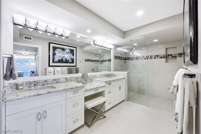 bathroom featuring vanity, tile patterned floors, and a shower with door