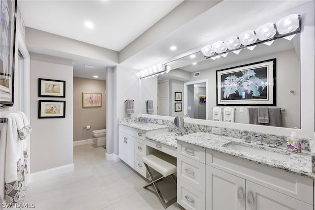 bathroom featuring tile patterned floors, toilet, and vanity