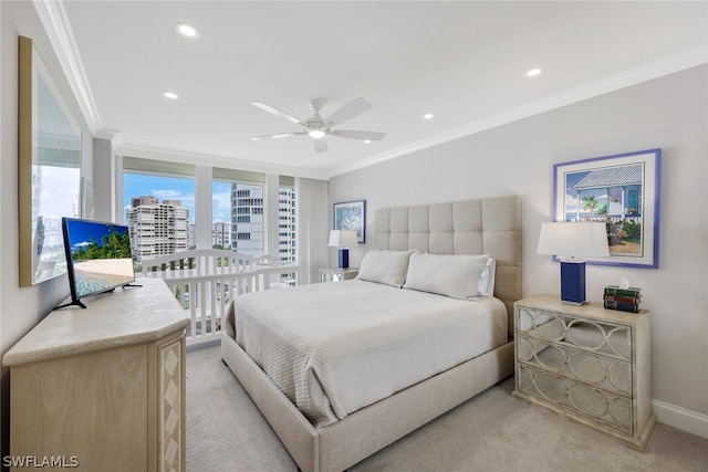 carpeted bedroom with ceiling fan and ornamental molding