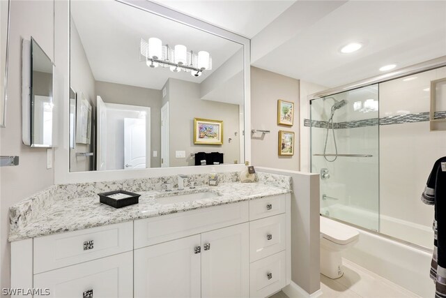 full bathroom with combined bath / shower with glass door, vanity, and toilet