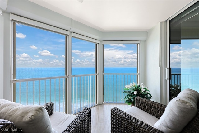 sunroom / solarium featuring a water view