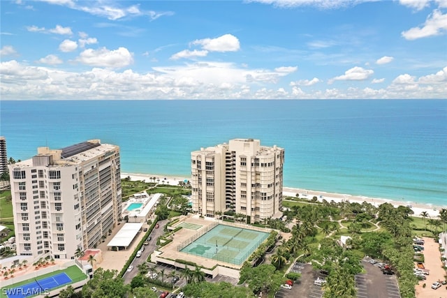 birds eye view of property with a water view and a view of the beach