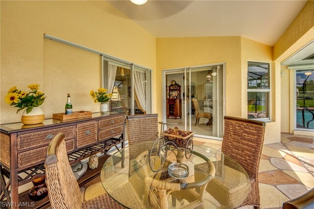 tiled dining space with vaulted ceiling