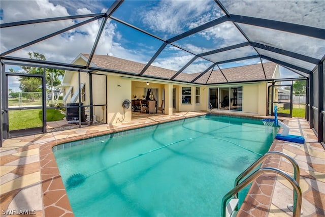 view of swimming pool featuring a patio and glass enclosure