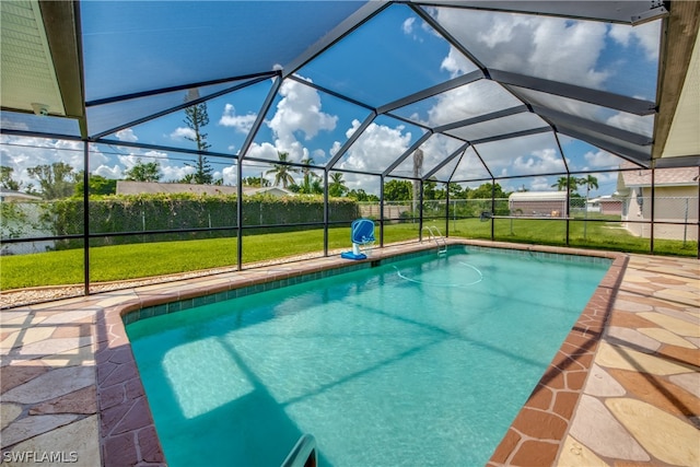 view of pool with a patio, a lawn, and glass enclosure