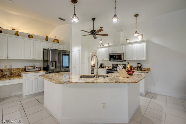 kitchen featuring light tile patterned floors, white cabinets, a kitchen island with sink, stainless steel appliances, and sink