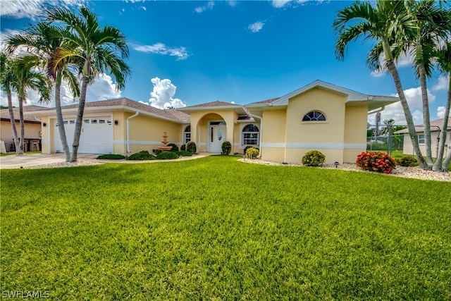 view of front of property with a garage and a front yard