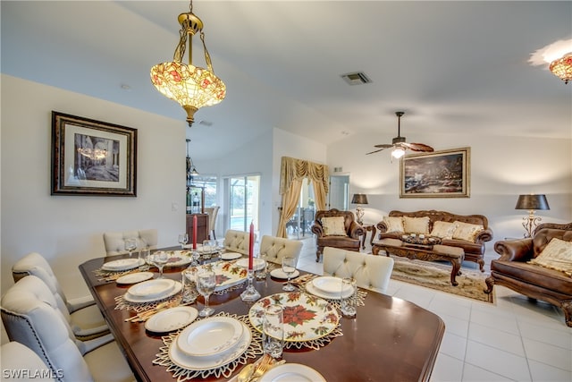 tiled dining area featuring lofted ceiling and ceiling fan