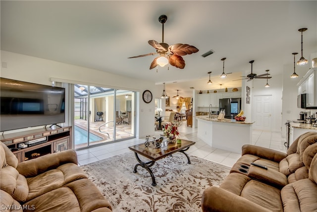 living room featuring light tile patterned flooring and ceiling fan