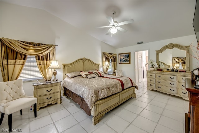 tiled bedroom featuring lofted ceiling and ceiling fan