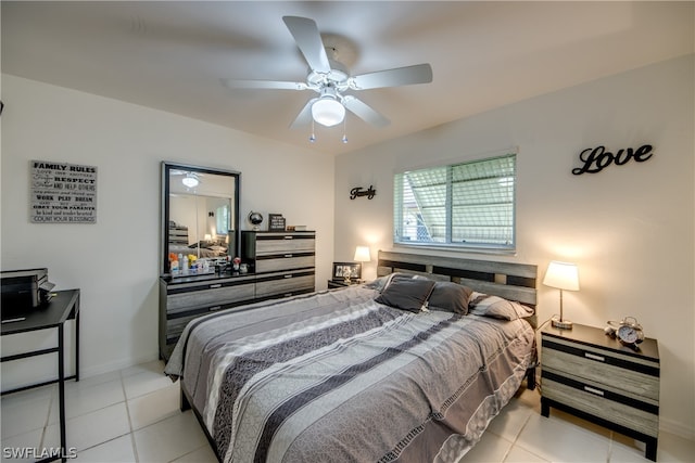 tiled bedroom featuring ceiling fan