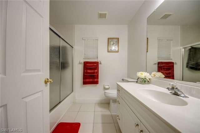 full bathroom featuring tile patterned floors, shower / bath combination with glass door, toilet, and vanity