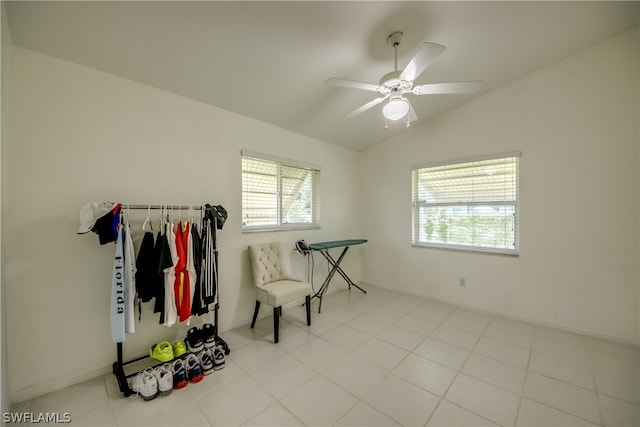 interior space featuring lofted ceiling, a healthy amount of sunlight, light tile patterned floors, and ceiling fan