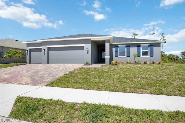 view of front of house with a garage and a front lawn