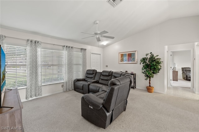 carpeted living room featuring ceiling fan and vaulted ceiling