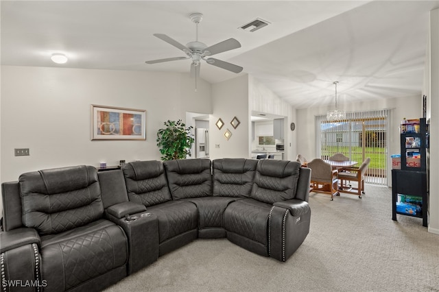 living room featuring carpet flooring, ceiling fan with notable chandelier, and vaulted ceiling