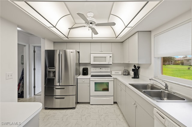 kitchen with white cabinetry, white appliances, light tile patterned floors, ceiling fan, and sink