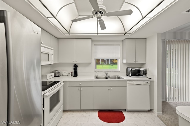 kitchen with sink, light tile patterned floors, ceiling fan, and stainless steel appliances