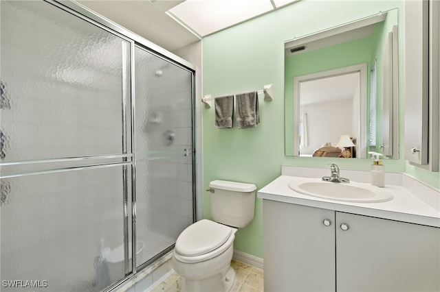 bathroom with tile patterned flooring, walk in shower, toilet, and vanity