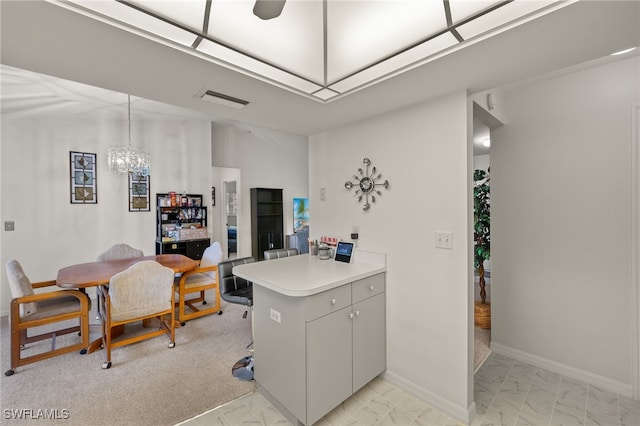 tiled office featuring an inviting chandelier