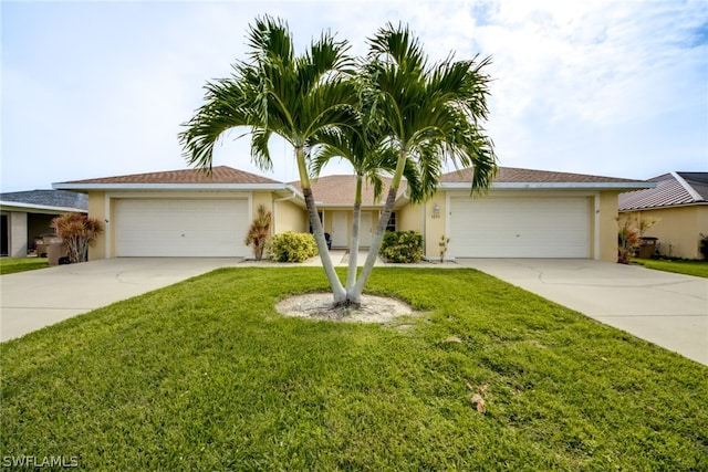 ranch-style home with a garage and a front lawn