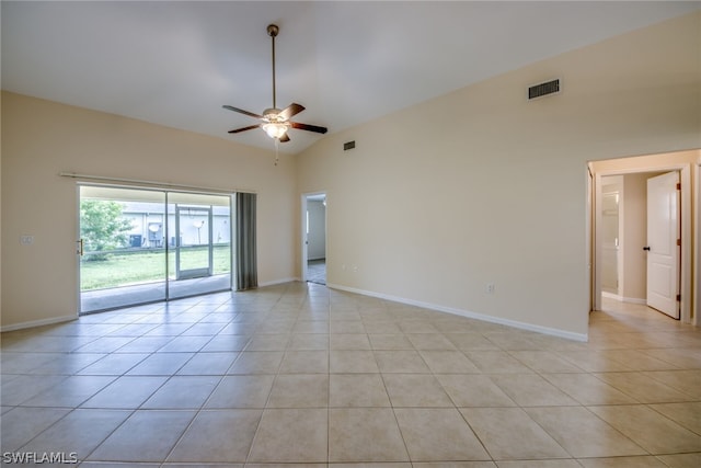 tiled empty room with ceiling fan and high vaulted ceiling