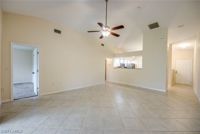 tiled empty room featuring ceiling fan and high vaulted ceiling