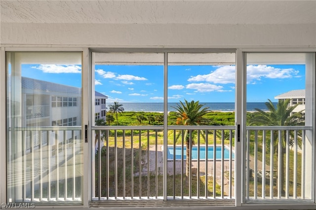 unfurnished sunroom featuring a water view