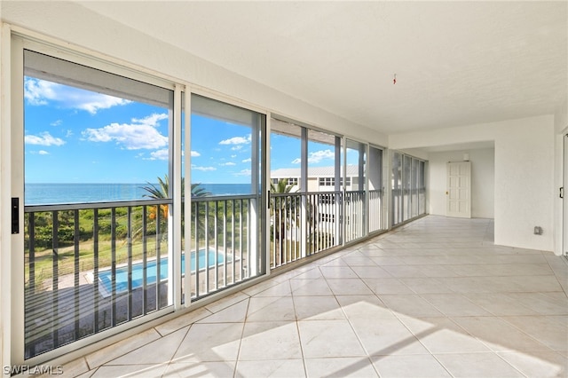 tiled spare room with a water view