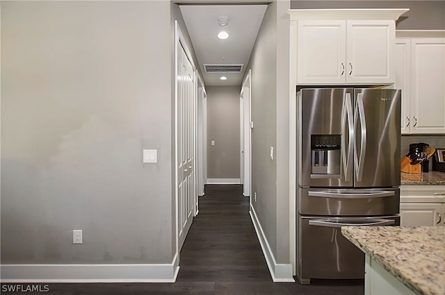 kitchen featuring dark wood-type flooring, white cabinets, light stone countertops, and stainless steel refrigerator with ice dispenser