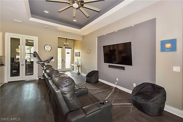 living room featuring french doors, dark hardwood / wood-style flooring, a raised ceiling, and ceiling fan