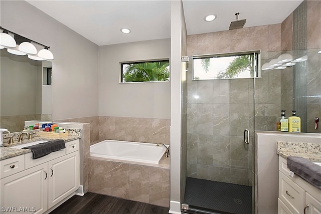 bathroom featuring vanity, separate shower and tub, and hardwood / wood-style flooring