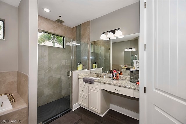 bathroom with vanity, hardwood / wood-style floors, and independent shower and bath