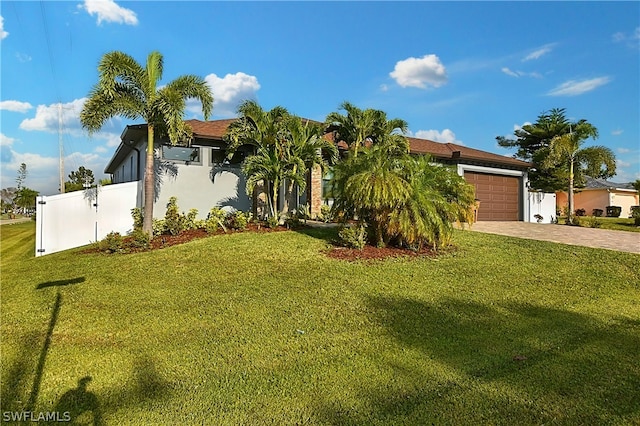 view of front of property with a garage and a front yard