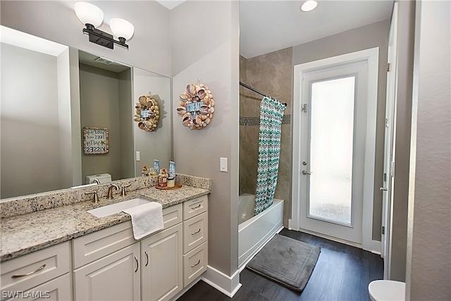 full bathroom with vanity, toilet, shower / tub combo, and hardwood / wood-style floors