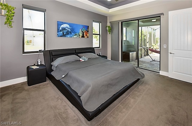 bedroom with access to exterior and dark carpet