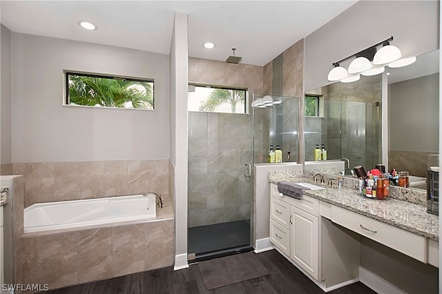 bathroom with vanity, hardwood / wood-style floors, and independent shower and bath