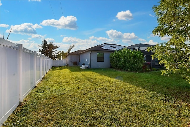 view of yard featuring glass enclosure