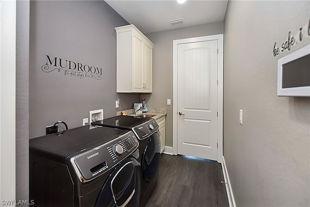 laundry area with separate washer and dryer, dark hardwood / wood-style flooring, cabinets, and sink