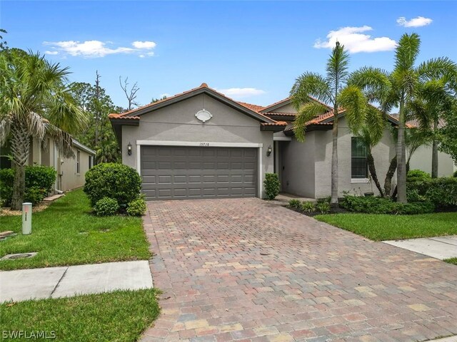 view of front of home with a garage and a front yard