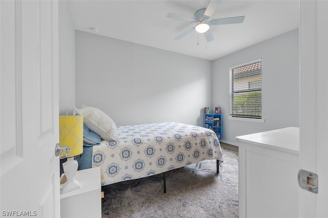 bedroom featuring ceiling fan and carpet