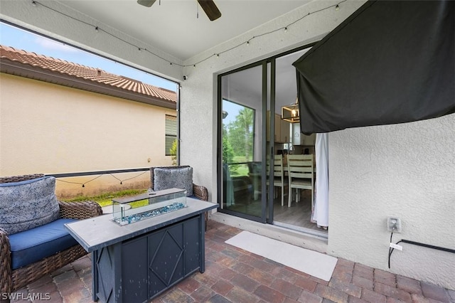 view of patio / terrace featuring ceiling fan and an outdoor fire pit