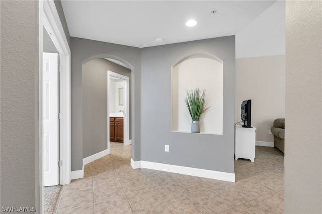 hallway featuring light tile patterned floors