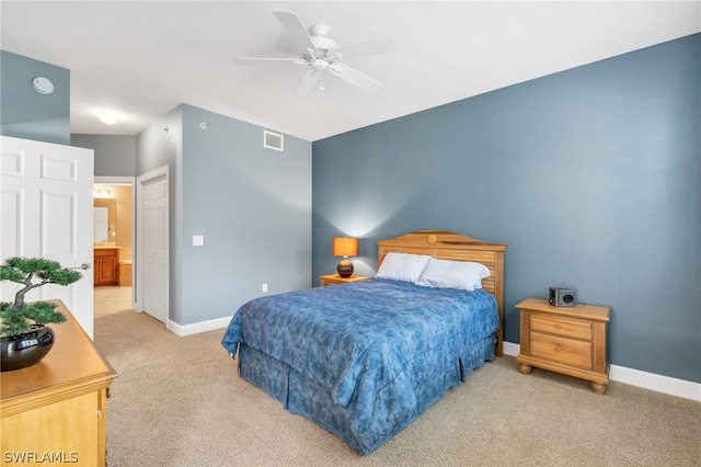 carpeted bedroom featuring ceiling fan and connected bathroom