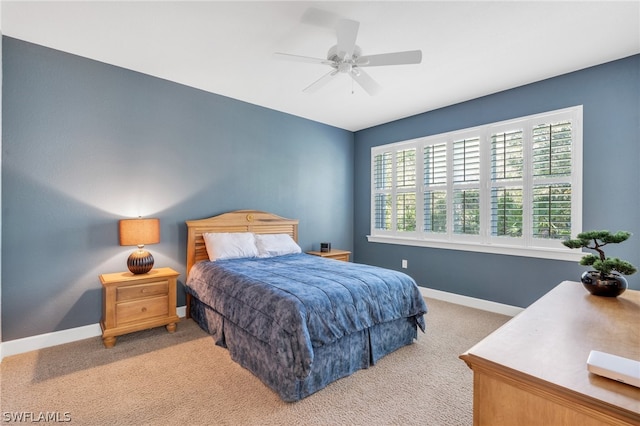 bedroom featuring ceiling fan and carpet