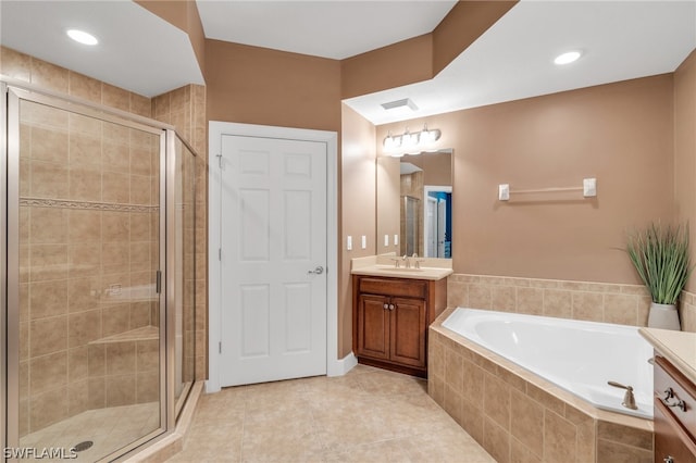 bathroom with plus walk in shower, tile patterned flooring, and vanity