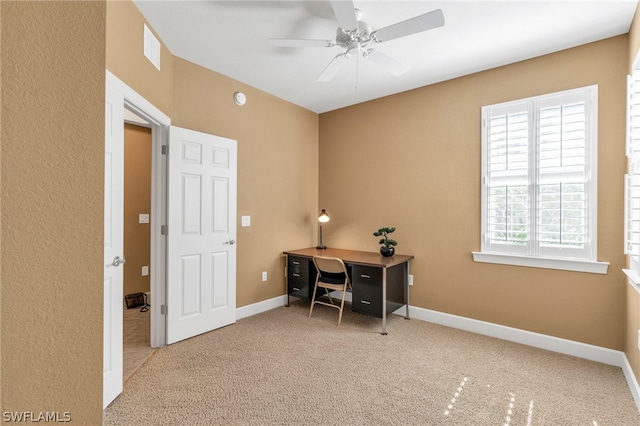 carpeted office with ceiling fan